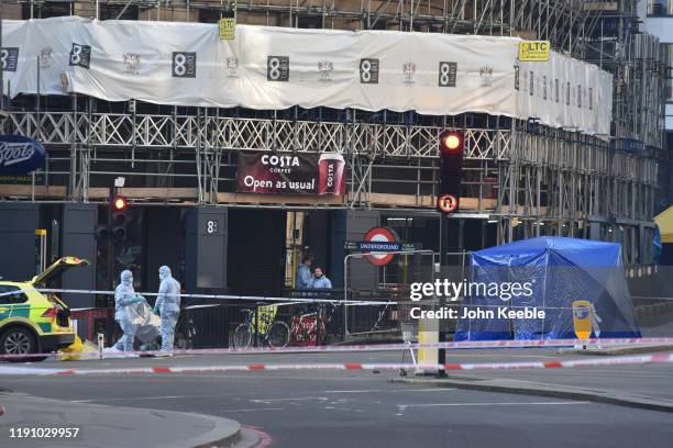 Forensic officers investigate the scene of yesterday's London Bridge stabbing attack on November 30, 2019 in London, England. A man and a woman were...