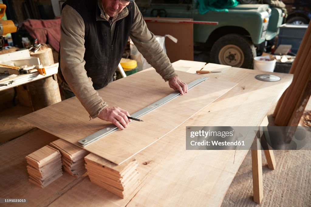 Worker measuring wood