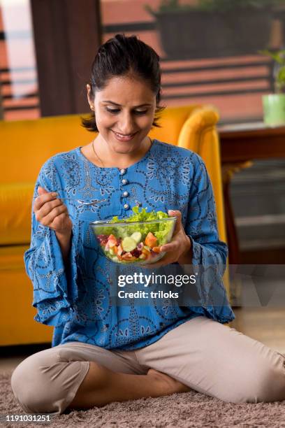 woman eating fruit salad - weight loss stock pictures, royalty-free photos & images