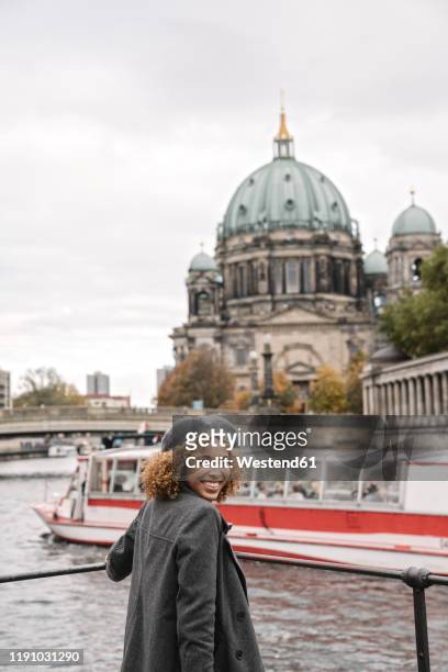 happy tourist woman in the city at spree river, berlin, germany - berlin spree stockfoto's en -beelden