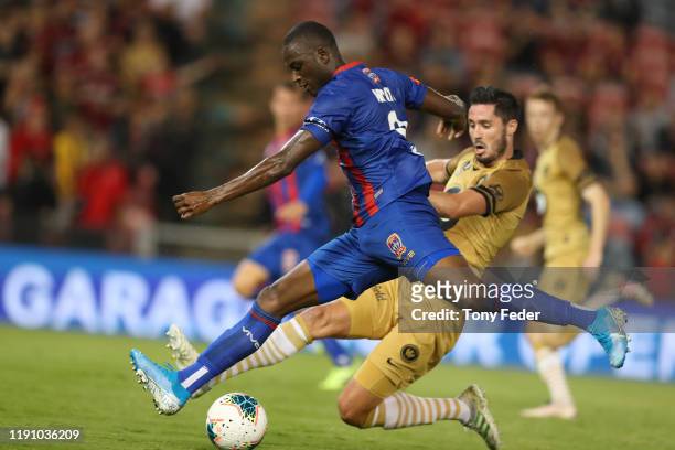 Abdiel Arroyo of the Newcastle Jets contests the ball with Dylan McGowan of the Western Sydney Wanderers during the round eight A-League match...