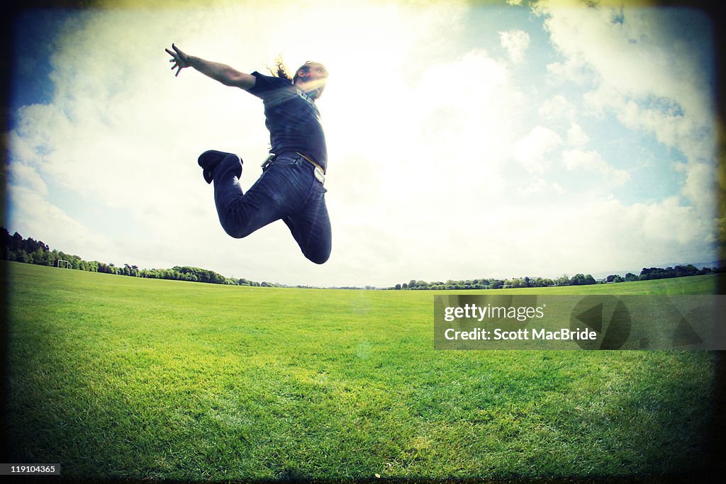 Man jumping in open field