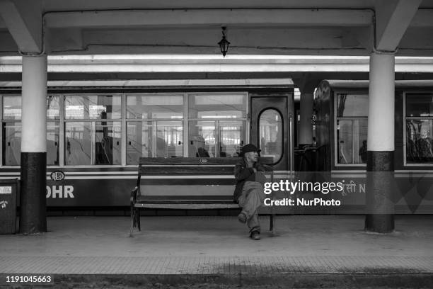 Image was converted to black and white) A passenger waits for the train at the platform in Darjeeling, India on 20th Dec'19. Darjeeling Himalayan...