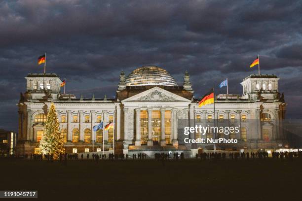 Reichstag Building is illuminated the night before New Year Eve Party at Brandenburg Gate in Berlin, Germany, on 30 December 2019.