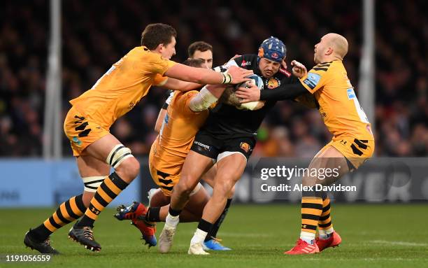 Jack Nowell of Exeter Chiefs is is tackled by Will Rowlands, Zurabi Zhvania and Dan Robson of Wasps during the Gallagher Premiership Rugby match...