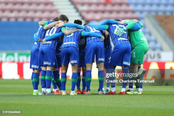 Wigan Athletic huddle prior to the Sky Bet Championship match between Wigan Athletic and Reading at DW Stadium on November 30, 2019 in Wigan, England.