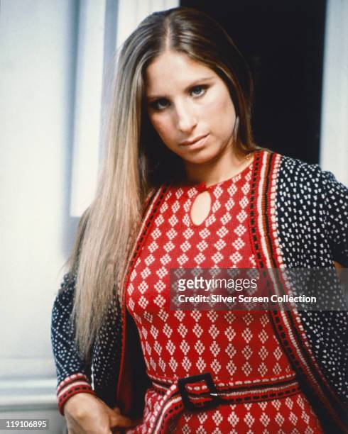 Barbra Streisand, US actress and singer, wearing a red-and-white woollen dress and a woollen cardigan, circa1965.