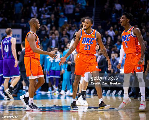 Chris Paul, and Terrance Ferguson of the Oklahoma City Thunder hi-five each other during the game against the Charlotte Hornets on December 27, 2019...