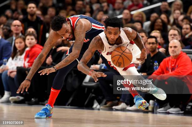 Derrick Jones Jr. #5 of the Miami Heat and Jordan McRae of the Washington Wizards go after the ball during the first half at Capital One Arena on...
