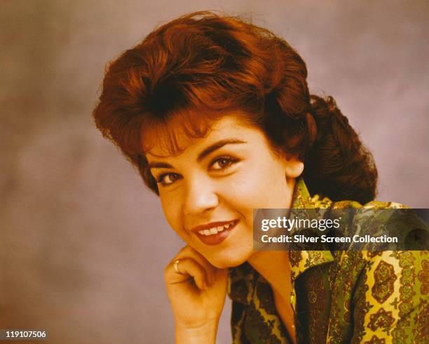 Headshot of Annette Funicello, US singer and actress, resting her chin on her hand, circa 1965.