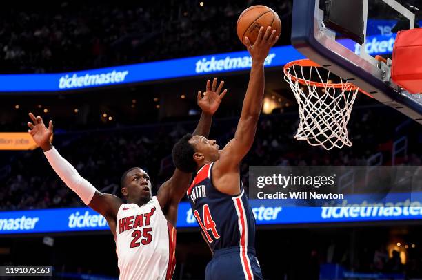 Ish Smith of the Washington Wizards shoots in front of Kendrick Nunn of the Miami Heat during the second half at Capital One Arena on December 30,...