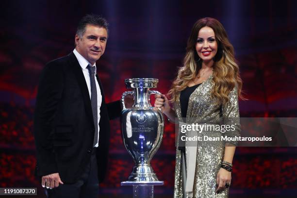 Theodoros Zagorakis, Former Greece player, and Joanna Lilli, his wife, pose for a photo with The Henri Delaunay Trophy after the UEFA Euro 2020 Final...