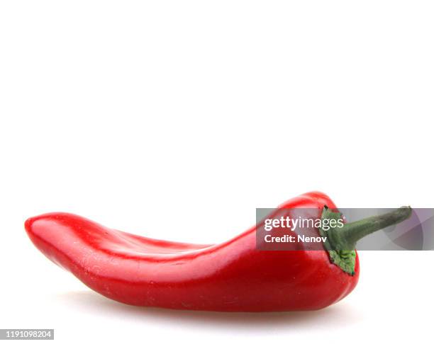 close-up of red chili pepper against white background - green chili pepper stock-fotos und bilder