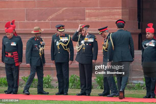 General Bipin Rawat, India's chief of defence staff, adjusts his hat after reviewing an honor guard at South Block of the Central Secretariat...