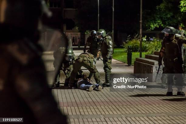 Osorno, Chile. 30 December 2019. Riot police arrest a protester. The latest demonstrations and protests of the year are strongly repressed by riot...