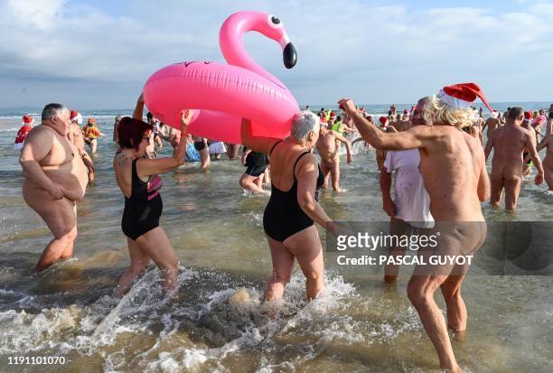 Graphic content / People take part in a traditional 'sea swim' to mark the New Year at a nudist beach in Le Cap d'Agde, southern France, on December...