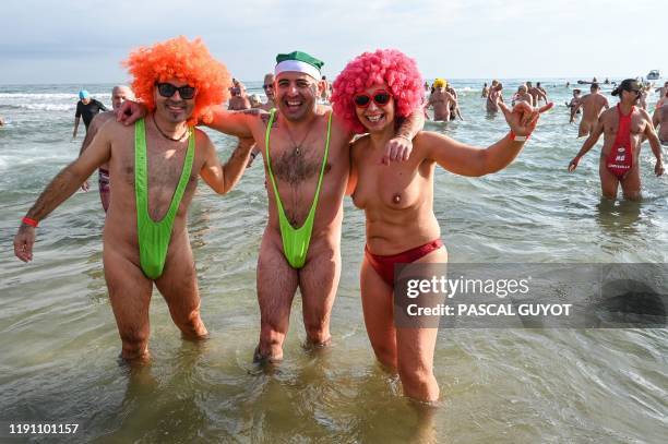 Graphic content / People take part in a traditional sea bath to mark the New Year's celebrations on a nudist beach in Le Cap d'Agde, southern France,...