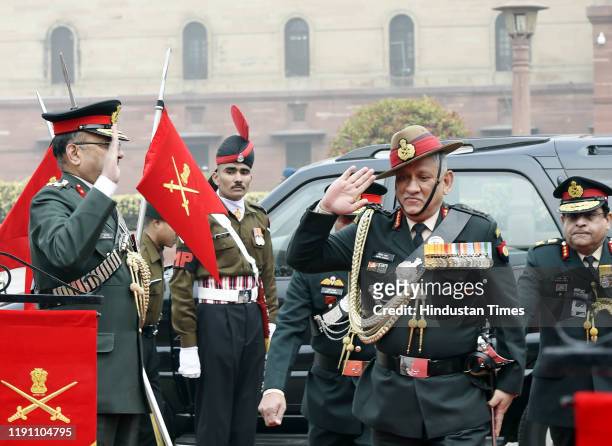 Outgoing Chief of Army Staff General Bipin Rawat salutes upon his arrival to inspect the Guard of Honour, at South Block lawns, on December 31, 2019...