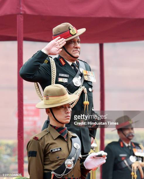 Outgoing Chief of Army Staff General Bipin Rawat salutes during the Guard of Honour, at South Block lawns, on December 31, 2019 in New Delhi, India....