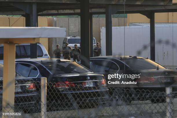 Soldiers stand guard as outraged Iraqi protesters storm the U.S. Embassy in Baghdad, protesting Washington's attacks on armed battalions belong to...