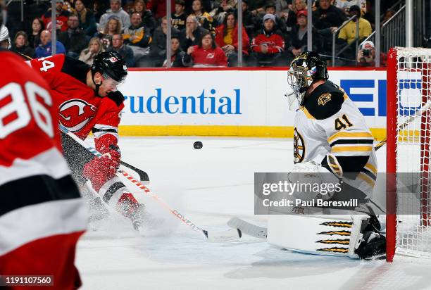 Goalie Jaroslav Halak of the Boston Bruins stops a shot by Miles Wood of the New Jersey Devils during the second period of an NHL hockey game on...