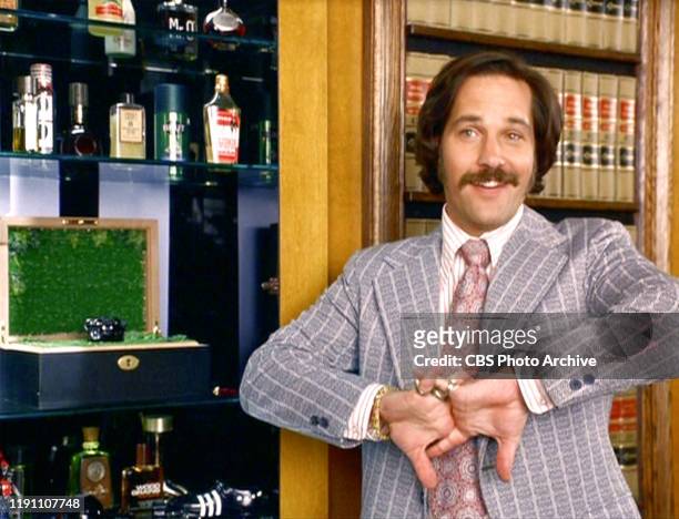 The movie "Anchorman: The Legend of Ron Burgundy", directed by Adam McKay. Seen here, Paul Rudd as Brian Fantana next to his cabinet filled with...