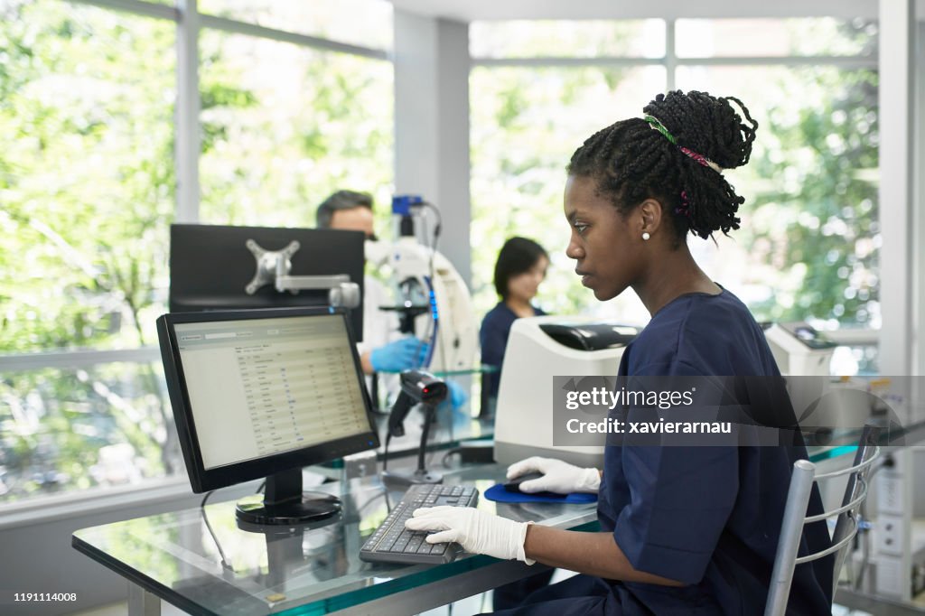 African Pathology Technician Working On Computer In Lab High-Res Stock ...