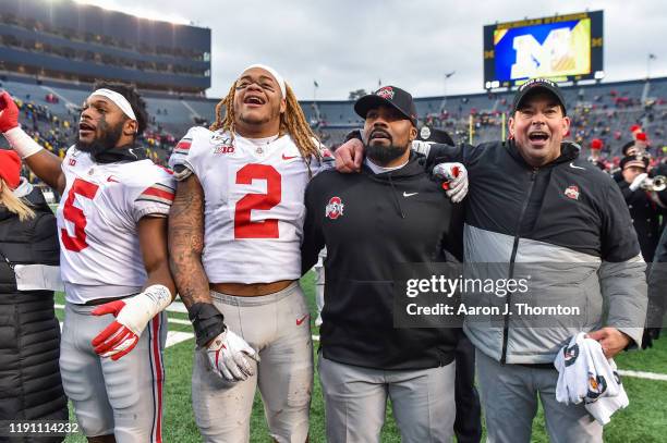 Baron Browning, Chase Young, Defensive Coach Al Washington, and Head Football Coach Ryan Day of the Ohio State Buckeyes celebrate after a college...