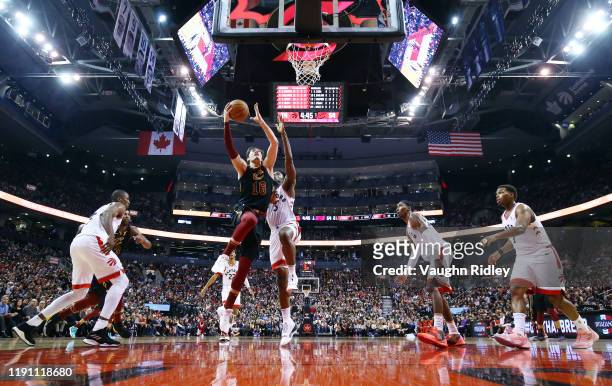 Cedi Osman of the Cleveland Cavaliers shoots the ball as OG Anunoby of the Toronto Raptors defends during the second half of an NBA game at...