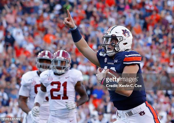Bo Nix of the Auburn Tigers reacts as he rushes for a touchdown against the Alabama Crimson Tide in the first half at Jordan Hare Stadium on November...
