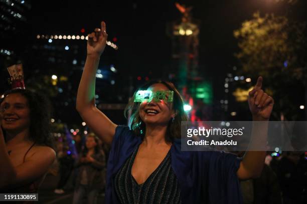 People are seen in the Angel de la Independencia in the New Year's eve celebaration in Mexico City, Mexico on December 31, 2019.