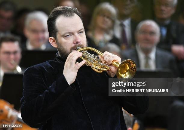 Latvian conductor Andris Nelsons plays the trumpet as he conducts the Vienna Philharmonic Orchestra during the "New Year's Concert 2020" at the...