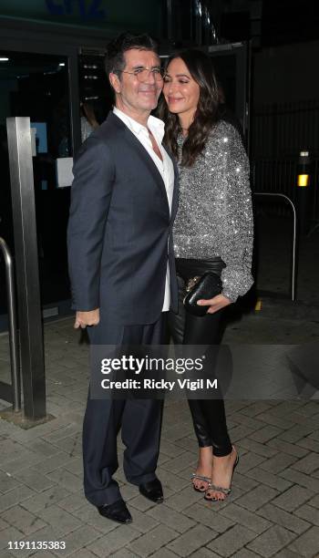 Simon Cowell and Lauren Silverman seen leaving LH2 studios after "The X Factor: Celebrity" on November 30, 2019 in London, England.