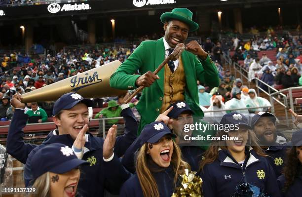 The Notre Dame Fighting Irish mascot, the leprechaun, cheers for his team with the cheerleaders during their game against the Stanford Cardinal at...