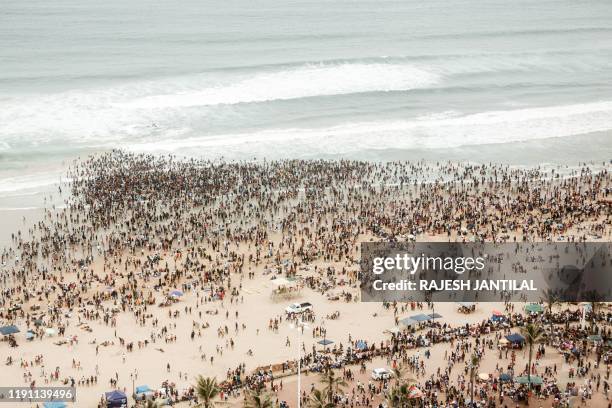 General view taken on on January 1, 2020 shows thousands of New Year's day revellers and holidaymakers gathering on North Pier Beach during New Year...
