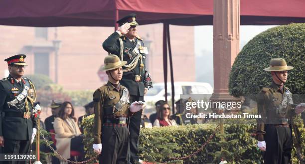 India's first Chief of Defence Staff Gen Bipin Rawat salutes during the Guard of Honour, at South Block lawns, on January 1, 2020 in New Delhi,...