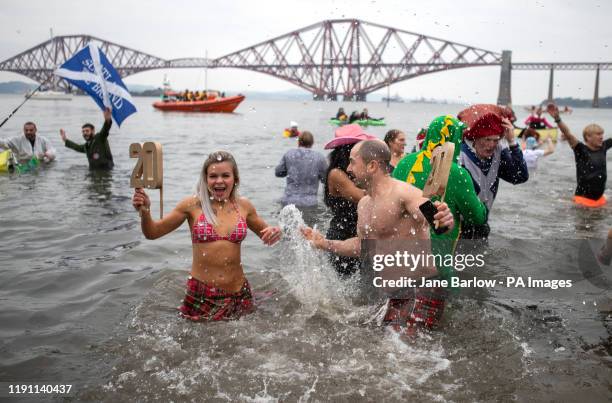 People take part in the Loony Dook New Year's Day dip in the Firth of Forth at South Queensferry, as part of Edinburgh's Hogmanay celebrations.