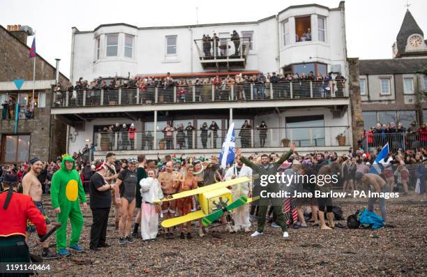 People take part in the Loony Dook New Year's Day dip in the Firth of Forth at South Queensferry, as part of Edinburgh's Hogmanay celebrations.