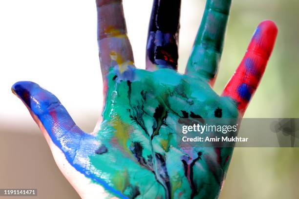 showing painted palm of hand with multi watercolors by herself - 9 hand drawn patterns bildbanksfoton och bilder