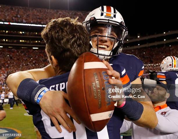 Bo Nix of the Auburn Tigers reacts after their 48-45 win over the Alabama Crimson Tide with Arryn Siposs at Jordan Hare Stadium on November 30, 2019...