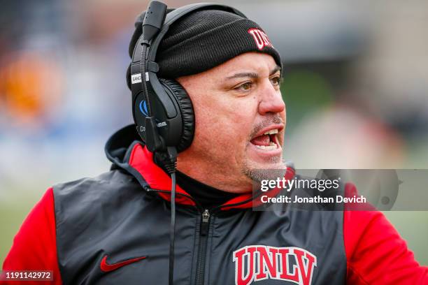 Head coach Tony Sanchez of the UNLV Rebels yells to players during the game between the Nevada Wolf Pack and the UNLV Rebels at Mackay Stadium on...