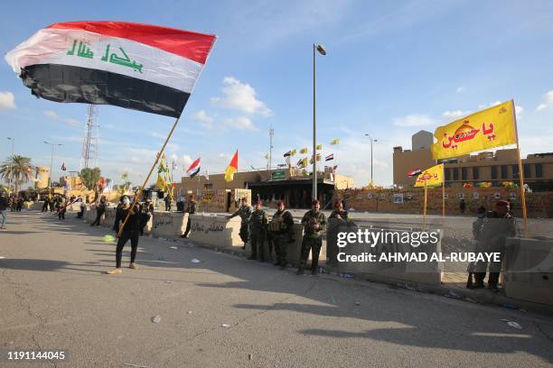 Iraqi security forces are deployed in front of the US embassy in the capital Baghdad, after an order from the Hashed al-Shaabi paramilitary force to...