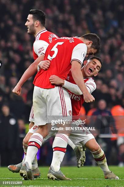 Arsenal's Greek defender Sokratis Papastathopoulos celebrates with Arsenal's Uruguayan midfielder Lucas Torreira after scoring their second goal...