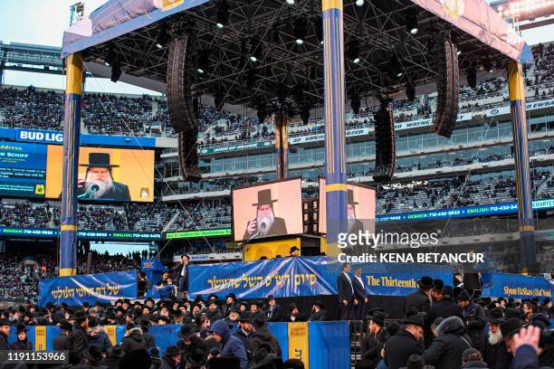 People gather in MetLife Stadium on January 1 in East Rutherford, New Jersey, to mark the Siyum HaShas, an event that celebrates the completion of...