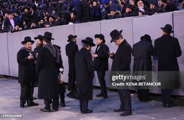 People congregate at the MetLife Stadium to celebrate Siyum HaShas, the completion of the reading of the Babylonian Talmud, on January 1 in East...