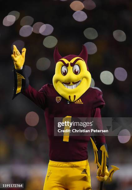 Arizona State Sun Devils mascot, "Sparky the Sun Devil " waves to fans during the second half of the NCAAF game against the Arizona Wildcats at Sun...