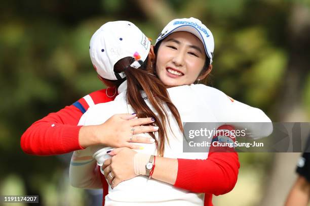 Seonwoo Bae of South Korea is congratulated by Bo-Mee Lee of South Korea after winning the tournament on the 18th green during the final round of the...