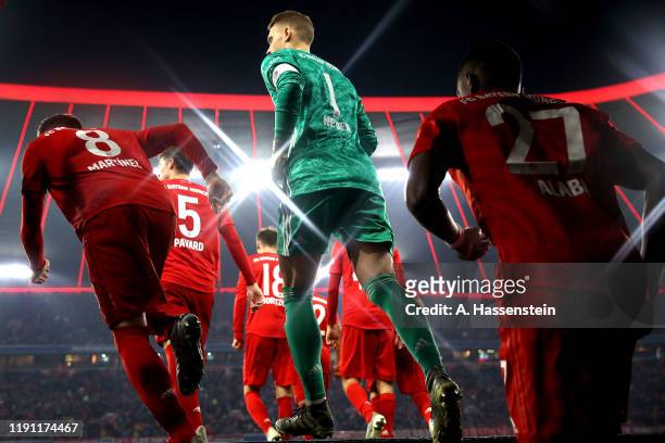 Manuel Neuer of FC Bayern Muenchen enters the field of play with his team mates at the players tunnel for the Bundesliga match between FC Bayern...