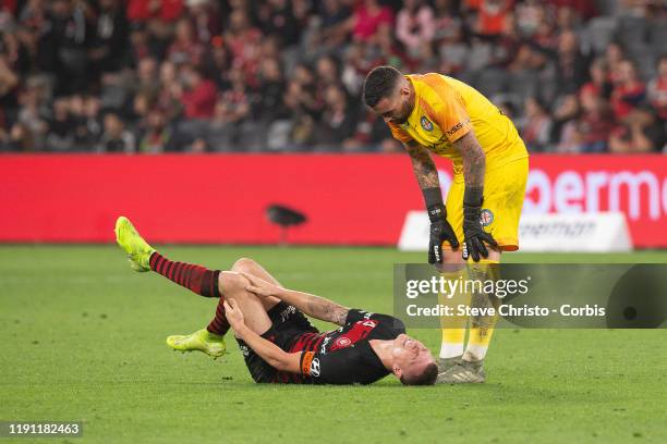 Mitchell Duke of the Wanderers is injured a tackle with City's Rostyn Griffiths is assisted by Dean Bouzanis during the round 7 A-League match...