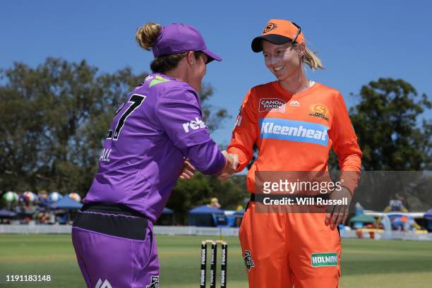 Corinne Hall of the Hurricanes and Meg Lanning of the Scorchers shake hands at the bat toss during the Women's Big Bash League match between the...